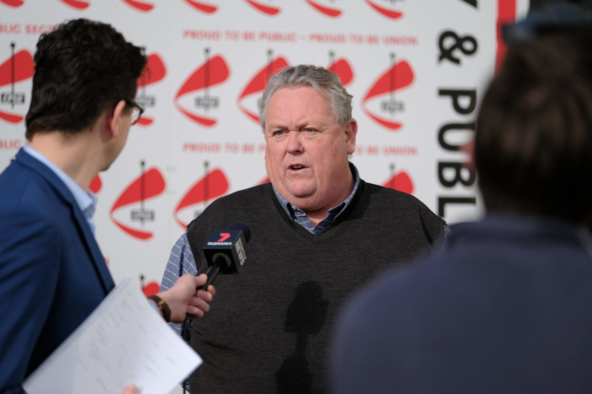 Man speaking to reporters